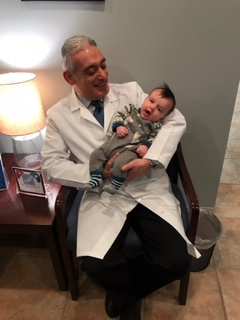 Dr Sharara holding their newborn baby son